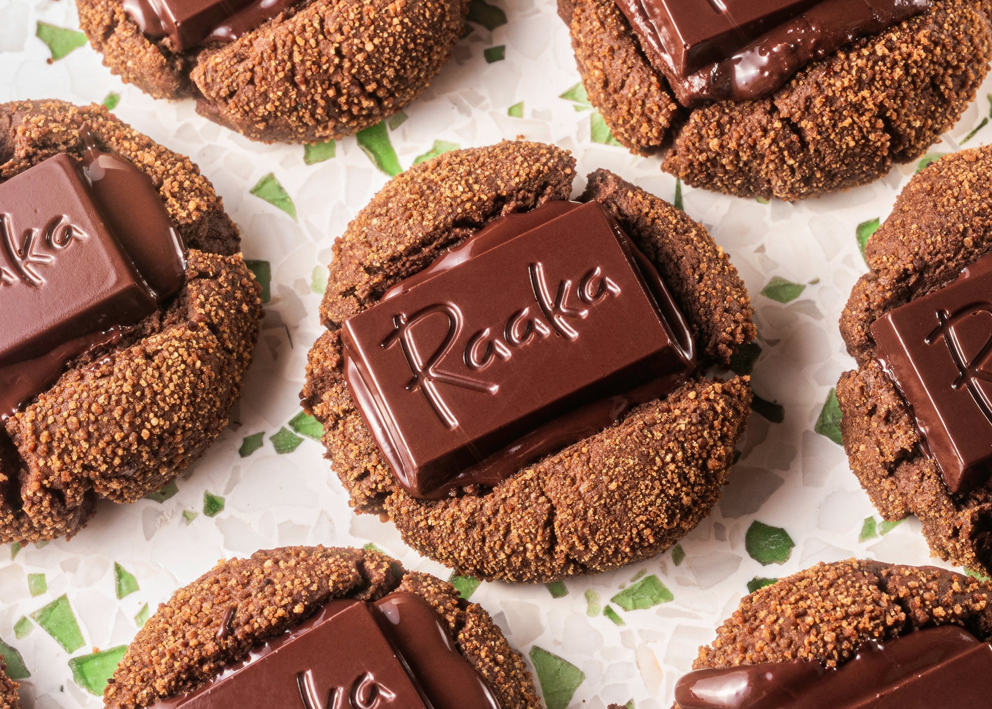 Chocolate cookies with a Raaka mini chocolate bar pressed into the top.