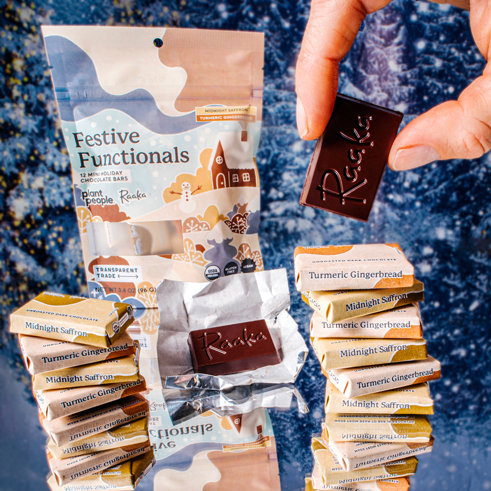 Stack of Midnight Saffron and Turmeric Ginger chocolate bars with Festive Functionals packaging on a textured blue background.