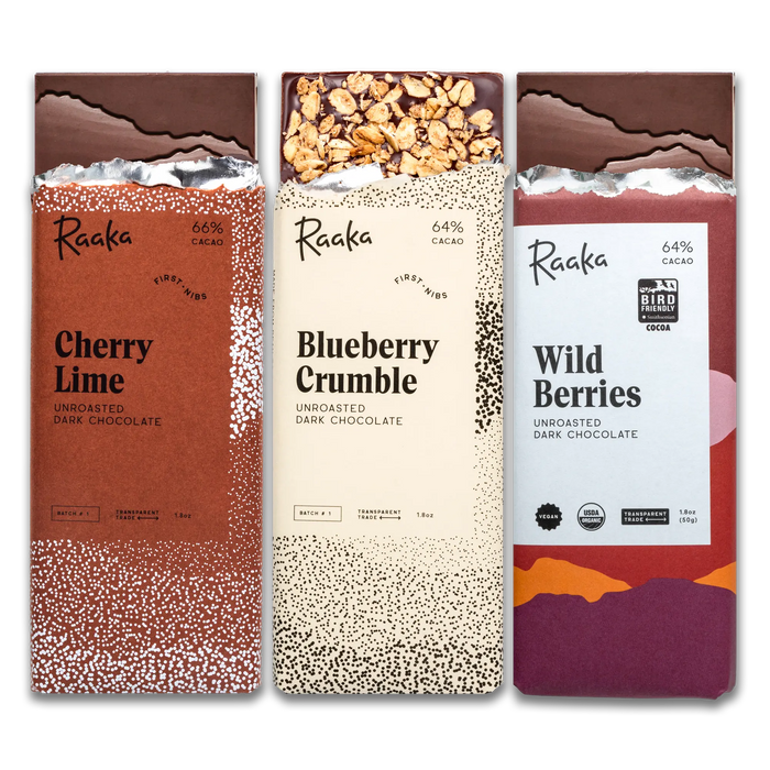 Three Raaka chocolate bars with different flavors and designs on a white background