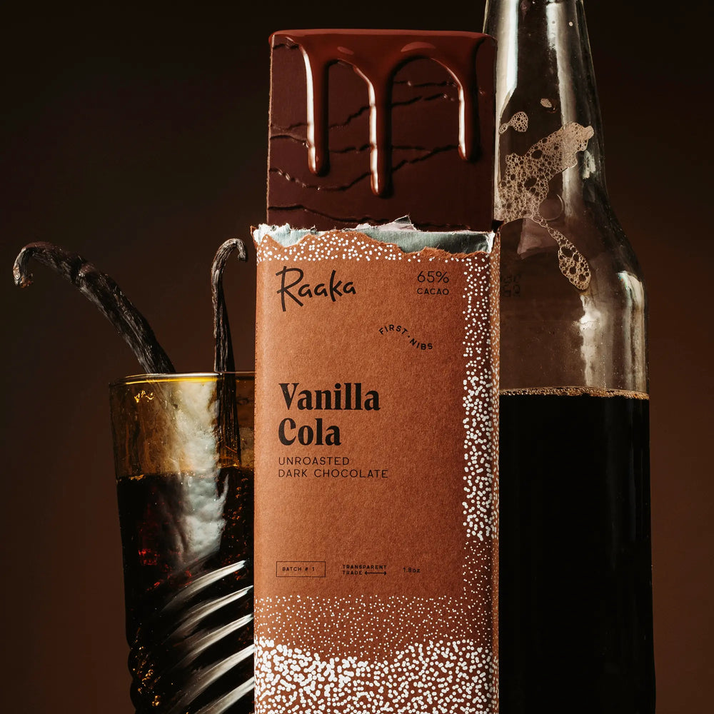 Vanilla Cola bar with cola bottles and vanilla beans around it.